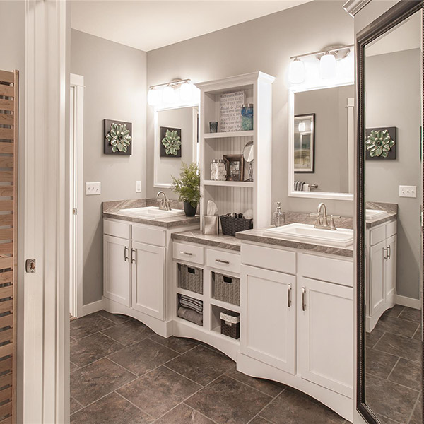 A modern-aesthetic bathroom with gray cabinetry and sleek appliances